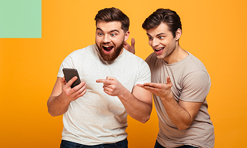 two excited men look at the phone screen.